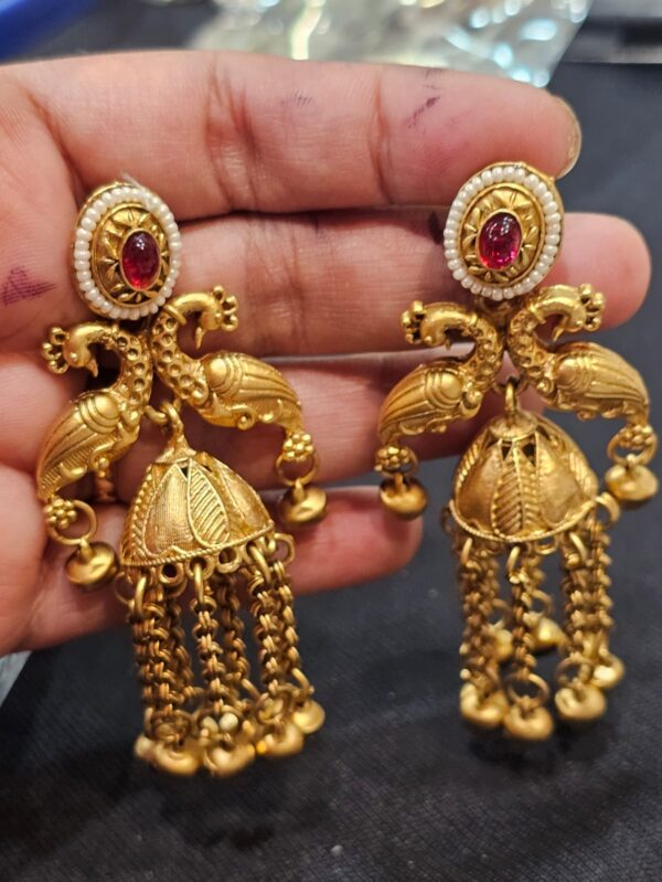 Antique Gold-Plated Peacock Jhumka Earrings with Ruby Red Stones, Pearl Borders, and Chain Tassels